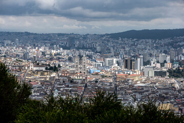 Cityscapes of the capital of Ecuador - Quito from the mountain on a cloudy day 