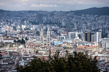 Cityscapes of the capital of Ecuador - Quito from the mountain on a cloudy day 