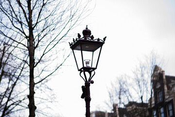 Vintage street lantern. Street lamp in Amsterdam. Architecture and street design. Urban street scape. Vintage toned image.