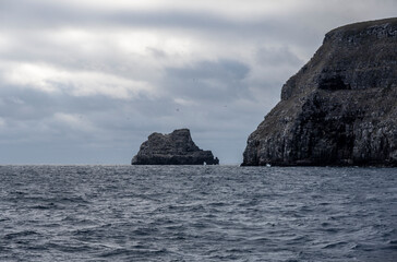 uninhabited islands of the Galapagos archipelago against the backdrop of the sea and blue sky 