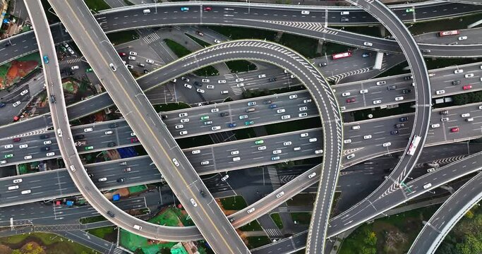 Aerial top overhead view time lapse of traffic on the flyover overpass Cars driving on the road at Chengdu China busy highway at evening camera down