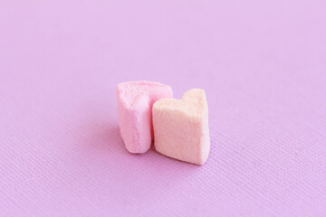 Two Marshmallow hearts on pink  background. Love, romance concept. Close up