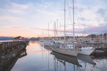 A serene winter sunset at the Comox marina on Vancouver Island, British Columbia, with peaceful...