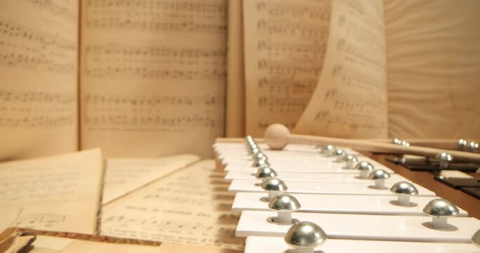 vibraphone lying on sheet music. SLIDER SHOT