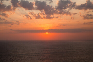 Beautiful sunset over the sea. Seascape. The sun is setting over the horizon.