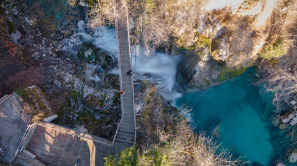 Aerial view of tourists standing on wooden bridge at the Sum Waterfall in the Vintgar gorge next to...