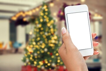 Hand hold modern phone with empty mockup screen on Christmas holidays.
