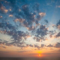 Beautiful sunset over the sea. Seascape. The sun is setting over the horizon.