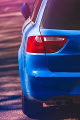 Close up view of rear headlight of blue car. Back side, half.