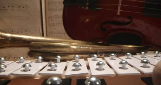 Violin, trumpet, vibraphone , cymbals lying on the notes. Musical instruments on a background with sheet music . Music, musical instruments, orchestra, sheet music,