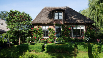 Plakat View of typical houses of Giethoorn, Netherlands. The beautiful houses and gardening city is know as 