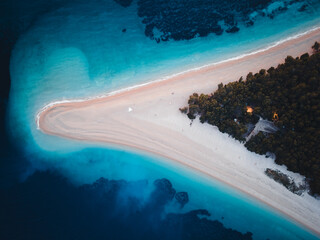 Top down view of famous Zlatni rat beach in Bol at night, first lights are on, Island Brac,...