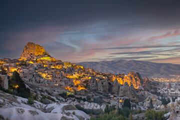 Naklejka premium Uchisar Castle in Pigeon Valley, Cappadocia, Turkey. Uchisar Castle is a very popular place for tourists. Fairy chimneys in Pigeon valley. Natural rocks forms, fairy chimneys.