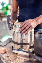 craftsman builds wooden barrels,