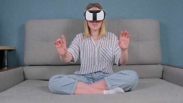 Virtual reality. The girl studies the game on the phono with glasses VR. metaverse, digital world, immersive project. The virtual world VR , interactive at home.Metaverse home,Immersive experience