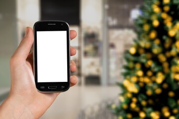 Hand hold modern phone with empty mockup screen on Christmas holidays.