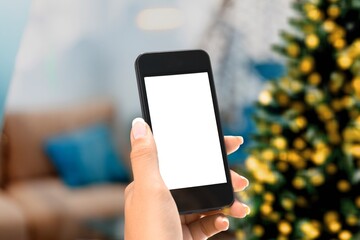 Hand hold modern phone with empty mockup screen on Christmas holidays.