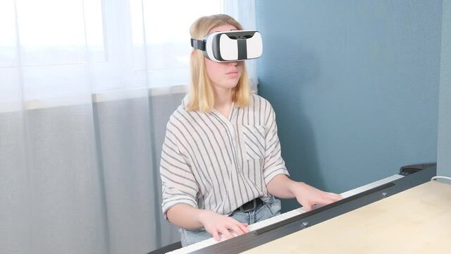 Virtual reality. The girl studies the game on the phono with glasses VR. metaverse, digital world, immersive project. The virtual world VR , interactive at home.Metaverse home,Immersive experience