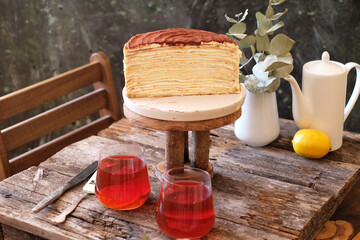 Fototapeta na wymiar Tiramisu Crepe Cake, no decor on a wooden table. Side View.