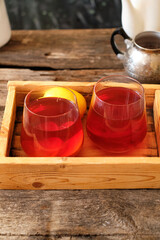 Tea with lemon. Wooden background, side view