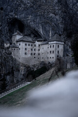 Moody, dark Predjama castle - Predjamski grad in spring, Slovenia