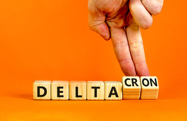 Covid-19 delta and deltacron symbol. Doctor turns cubes and changes the word delta to deltacron....