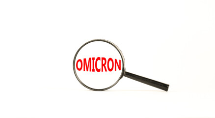 Covid-19 corona and omicron symbol. The concept word Omicron. Magnifying glass. Beautiful white table, white background. Medical covid-19 corona omicron concept. Copy space.
