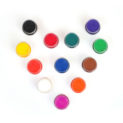 Acrylic colors isolated on a white background in the form of a heart