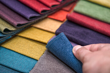 Samples of textiles for upholstery in different colors and thicknesses. Closeup details of...