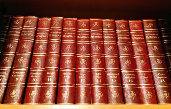A book series of volumes of the Encyclopedia Britannica on a library shelf