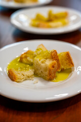 Tasting of Italian extra virgin olive oil with bread on organic farm in Tuscany, Italy