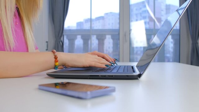 Hands of freelancer woman typing text on laptop comuter keyboard in home office. Female working online during lockdown. Person using notebook pc for distant work in 4k stock video