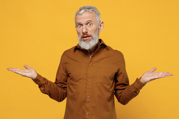 Confused puzzled elderly gray-haired bearded man 40s years old wears brown shirt looking camera...