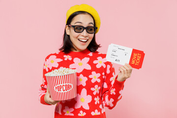 Young excited fun cool woman of Asian ethnicity in 3d glasses watch movie film hold bucket of popcorn ticket isolated on yellow background studio portrait. People emotions in cinema lifestyle concept.