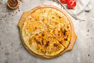 Focaccia with rosemary on the board on grey concrete table top view