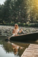 A woman sitting in a boat and oaring