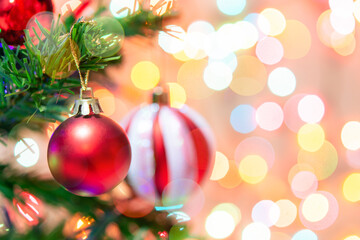 Christmas decoration. Red balls hanging on pine branches Christmas tree garland and ornaments over abstract bokeh background with copy space