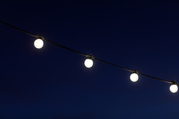 garlands of light bulbs in the dark