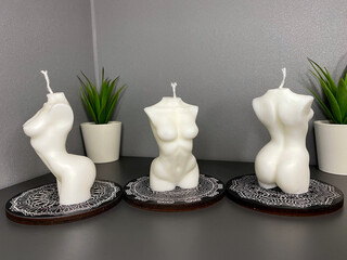 three trendy soy candle female bodies on the grey table