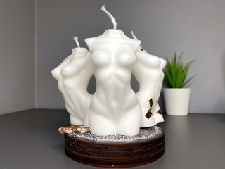 three trendy soy candle female bodies on the grey table
