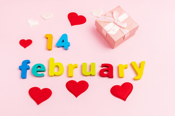 Valentines Day a pink background. A gift box with the inscription February 14. Top view. Vertical photo