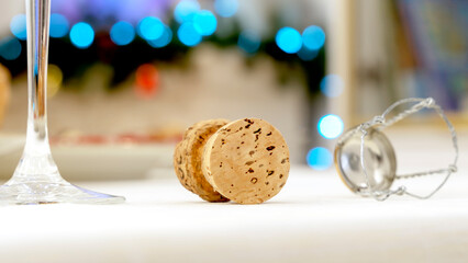 a glass of champagne and a cork on a festive New Year's table