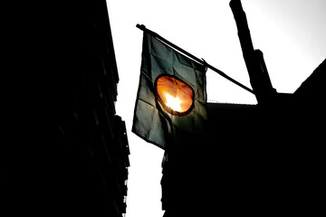 The national flag of Bangladesh is flying in the sky. The flag of Bangladesh is made of a center...