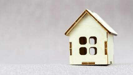 Put the wooden model of the house on the fabric. the concept of real estate investment. planning to save money in coins for the purchase of a house for rea