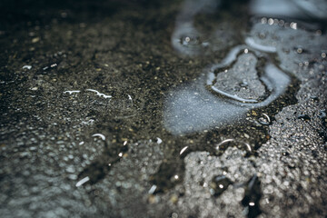 water on a black stone table with white crumbs