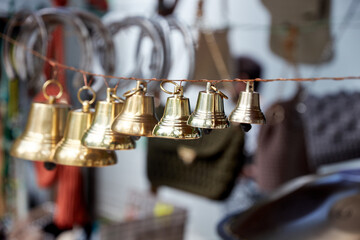 small bronze bells suspended on a rope