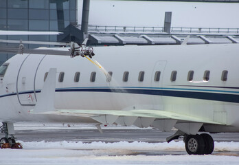 Deicing an airplane in winter, spraying an airplane with an anti-icing liquid in winter