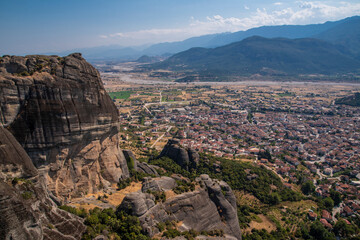 Beautiful scenic view of the small Kalabaka town on top of the cliff, from Holy Trinity Monastery (Agia Trias), trough Meteora rock formations, Greece.
