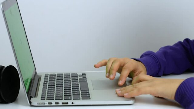 Hands of a mixed-race woman writing a text on a laptop keyboard in close-up. Software, online education, apps, the concept of modern technology.
