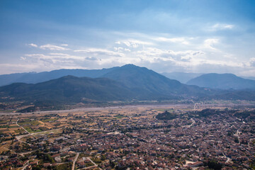 Beautiful scenic view of the small Kalabaka town on top of the cliff, from Holy Trinity Monastery (Agia Trias), trough Meteora rock formations, Greece.